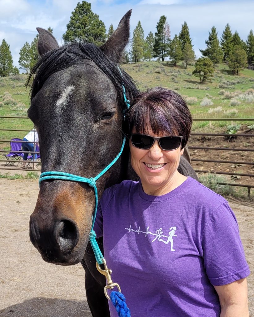 Photo of Rebecca Holland next to a horse